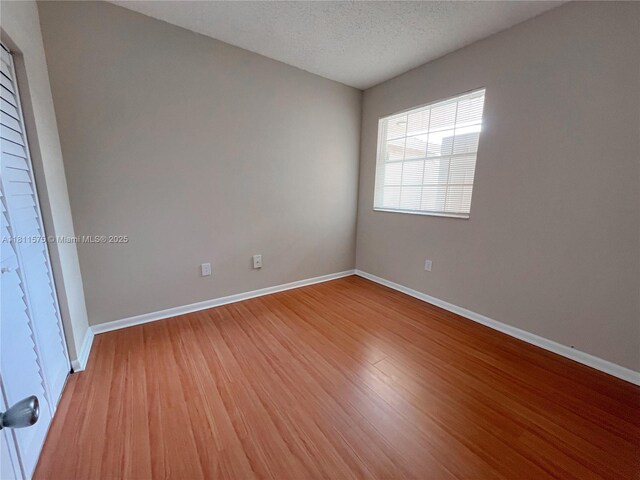 1881 NW 96th Ter Unit 7C, Pembroke Pines, FL 33024 - unfurnished room featuring light wood-style floors and a textured ceiling