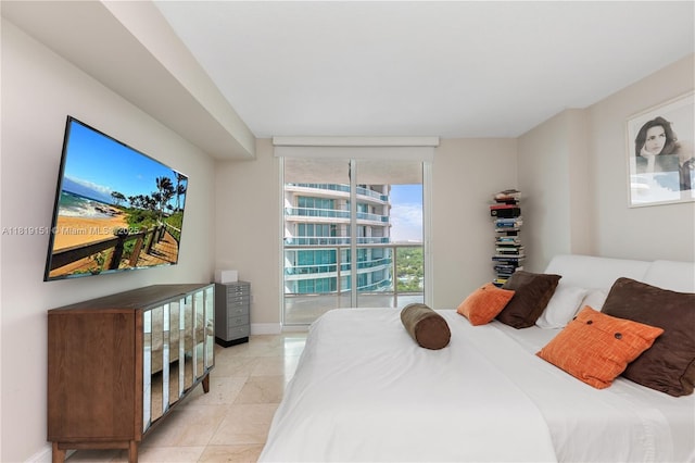 2101 Brickell Ave Unit 2409, Miami, FL 33129 - bedroom with baseboards, light tile patterned flooring, and expansive windows