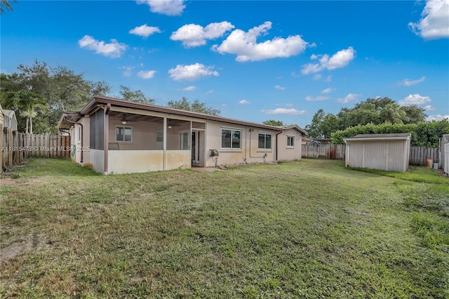 8331 NW 18th St, Pembroke Pines, FL 33024 - back of house with a sunroom, a fenced backyard, a storage shed, a ceiling fan, and stucco siding