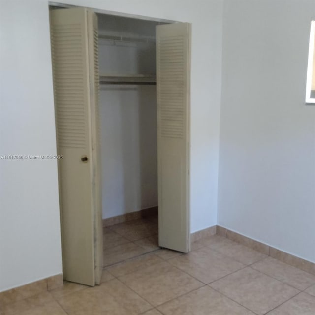 6201 SW 37th St Unit 113, Davie, FL 33314 - unfurnished bedroom with a closet and light tile patterned floors