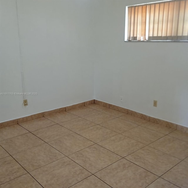 6201 SW 37th St Unit 113, Davie, FL 33314 - spare room featuring light tile patterned floors and baseboards