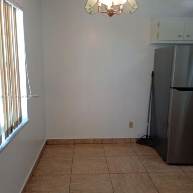 6201 SW 37th St Unit 113, Davie, FL 33314 - unfurnished dining area featuring a chandelier, light tile patterned floors, and plenty of natural light
