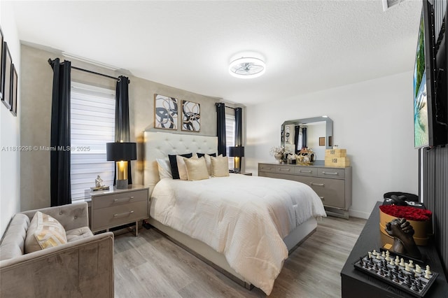 bedroom featuring light wood finished floors