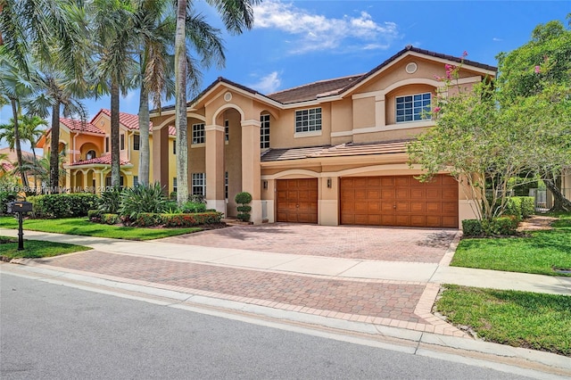 2509 Hunters Run Way, Weston, FL 33327 - view of front of house featuring stucco siding, a garage, decorative driveway, and a tiled roof