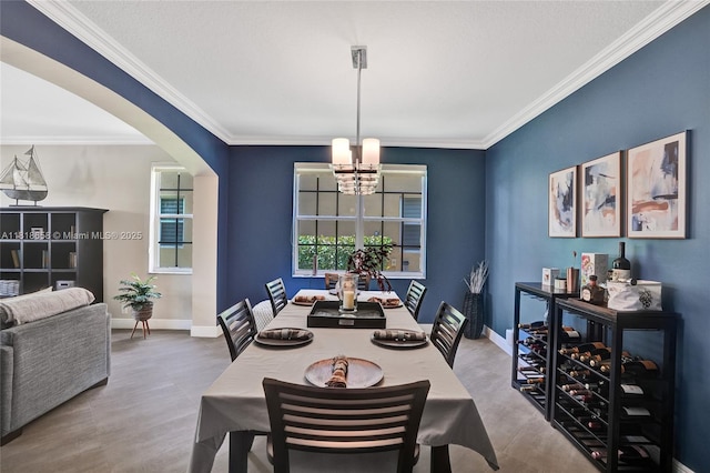 2509 Hunters Run Way, Weston, FL 33327 - dining area featuring arched walkways, a chandelier, crown molding, and wood finished floors