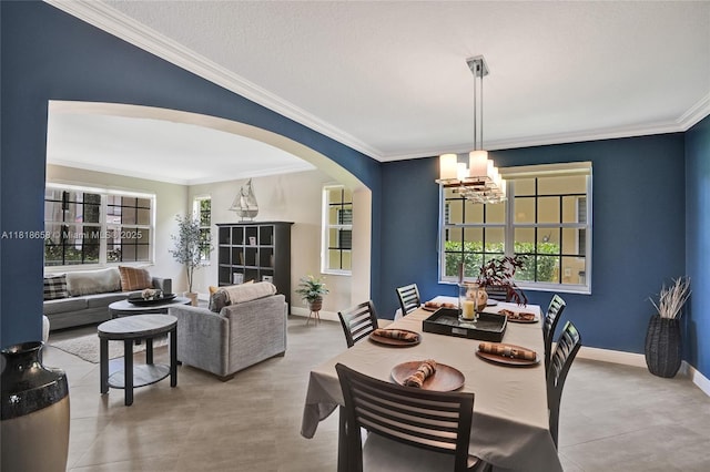 2509 Hunters Run Way, Weston, FL 33327 - dining space featuring a chandelier, arched walkways, and ornamental molding