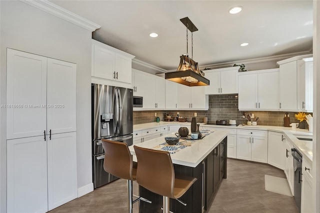 2509 Hunters Run Way, Weston, FL 33327 - kitchen featuring appliances with stainless steel finishes, ornamental molding, a kitchen island, light countertops, and white cabinetry