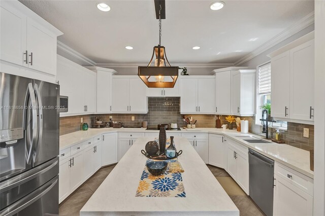 2509 Hunters Run Way, Weston, FL 33327 - kitchen with appliances with stainless steel finishes, white cabinetry, ornamental molding, a kitchen island, and tasteful backsplash