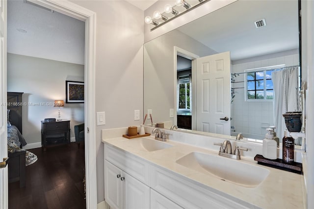 2509 Hunters Run Way, Weston, FL 33327 - ensuite bathroom featuring double vanity, wood finished floors, and shower / tub combo