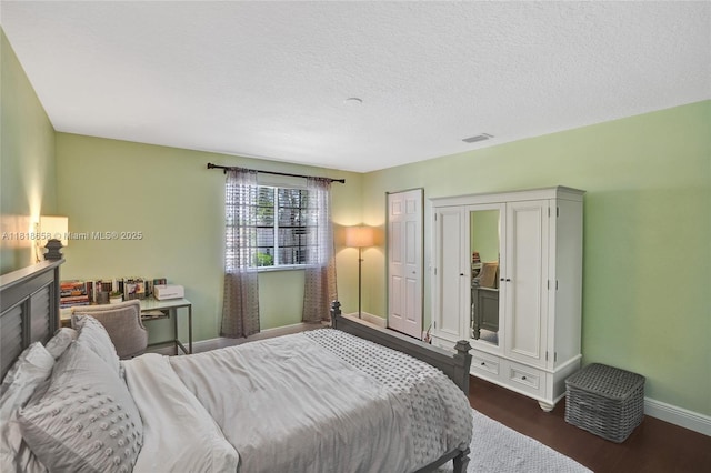 2509 Hunters Run Way, Weston, FL 33327 - bedroom with dark wood-type flooring and a textured ceiling