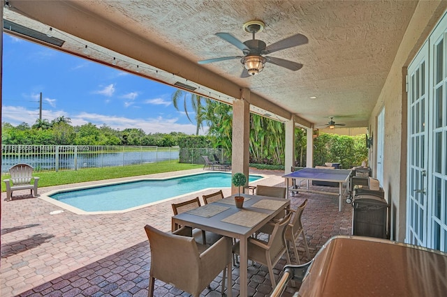 2509 Hunters Run Way, Weston, FL 33327 - view of swimming pool featuring outdoor dining area, ceiling fan, a patio, a water view, and a fenced backyard