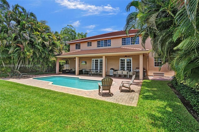 2509 Hunters Run Way, Weston, FL 33327 - rear view of property with stucco siding, a yard, a patio area, outdoor lounge area, and an outdoor pool
