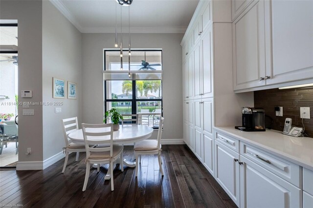 9368 Eden Roc Ct, Delray Beach, FL 33446 - dining space with dark wood-style floors, baseboards, ceiling fan, and ornamental molding