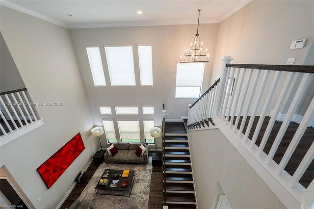 9368 Eden Roc Ct, Delray Beach, FL 33446 - living area featuring a high ceiling, a chandelier, stairs, and crown molding