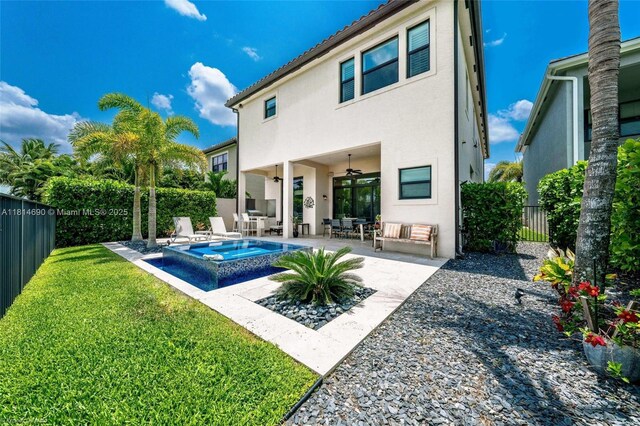 9368 Eden Roc Ct, Delray Beach, FL 33446 - back of house with a ceiling fan, an in-ground hot tub, stucco siding, and a patio