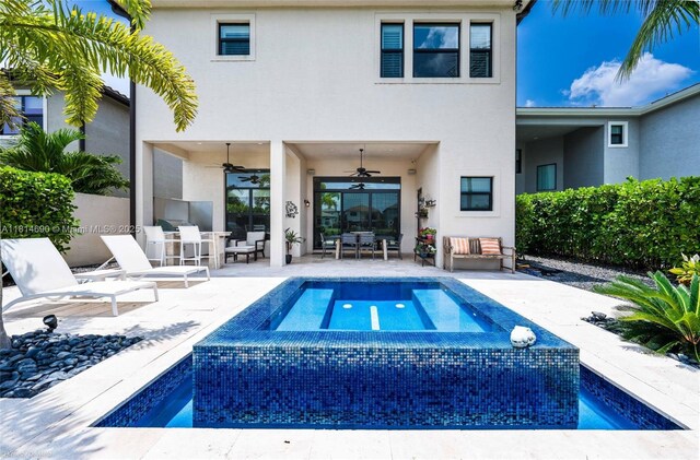 9368 Eden Roc Ct, Delray Beach, FL 33446 - rear view of property featuring stucco siding, a ceiling fan, a patio, and an in-ground hot tub