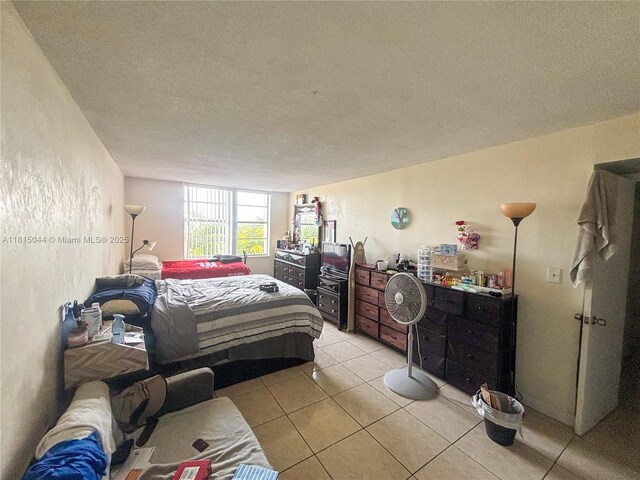 498 NW 165th St Rd Unit D-405, Miami, FL 33169 - bedroom featuring light tile patterned floors and a textured ceiling