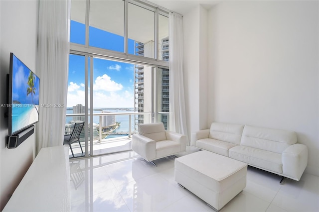 475 Brickell Ave Unit 2807, Miami, FL 33131 - living area with tile patterned floors, a water view, floor to ceiling windows, and a high ceiling