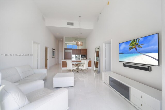 475 Brickell Ave Unit 2807, Miami, FL 33131 - living area with a towering ceiling, a chandelier, and light tile patterned floors