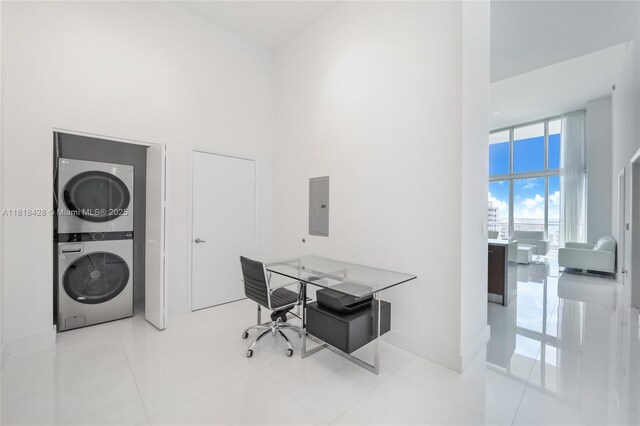 475 Brickell Ave Unit 2807, Miami, FL 33131 - tiled home office featuring stacked washer and clothes dryer, a high ceiling, and electric panel
