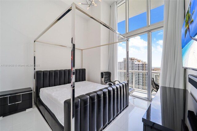 475 Brickell Ave Unit 2807, Miami, FL 33131 - tiled bedroom with multiple windows, a city view, and access to exterior