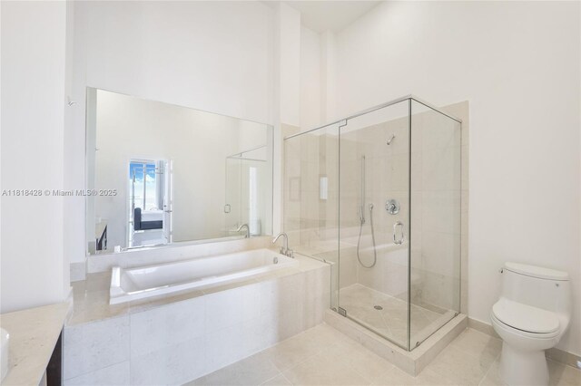 475 Brickell Ave Unit 2807, Miami, FL 33131 - full bath featuring a garden tub, a stall shower, toilet, tile patterned flooring, and vanity