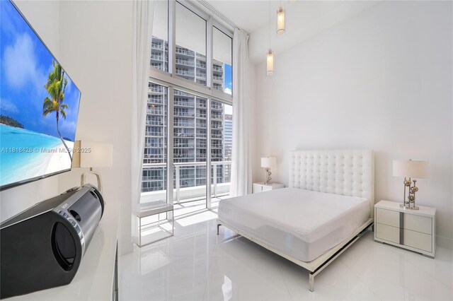 475 Brickell Ave Unit 2807, Miami, FL 33131 - tiled bedroom featuring multiple windows and expansive windows