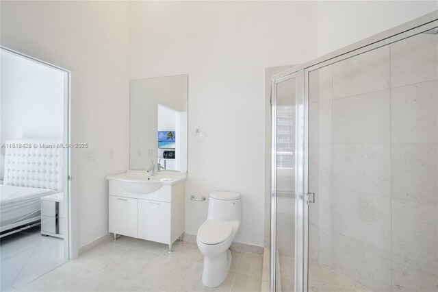475 Brickell Ave Unit 2807, Miami, FL 33131 - ensuite bathroom with vanity, a shower stall, toilet, tile patterned floors, and baseboards