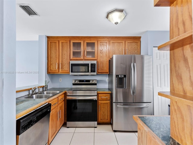 17337 SW 140th Ct, Miami, FL 33177 - kitchen featuring stainless steel appliances, a sink, brown cabinetry, and light tile patterned flooring