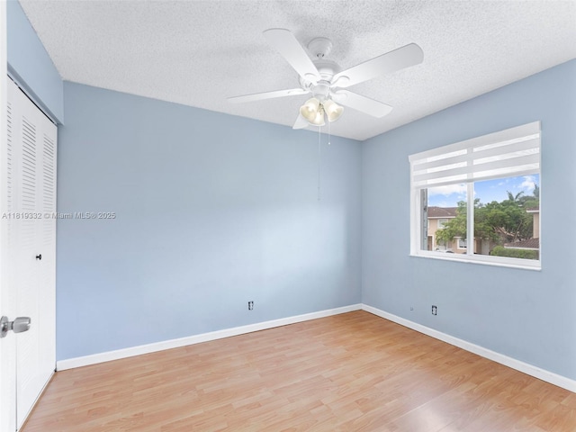 17337 SW 140th Ct, Miami, FL 33177 - unfurnished bedroom featuring light wood-style flooring, a textured ceiling, a closet, baseboards, and ceiling fan
