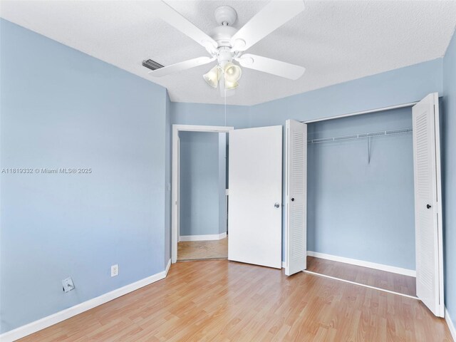 17337 SW 140th Ct, Miami, FL 33177 - unfurnished bedroom featuring wood finished floors, baseboards, a closet, ceiling fan, and a textured ceiling