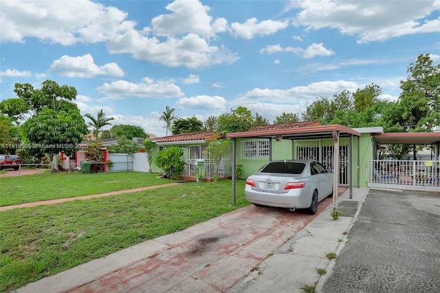 1150 W 69th Pl, Hialeah, FL 33014 - view of front of house featuring stucco siding, driveway, a carport, and a tile roof