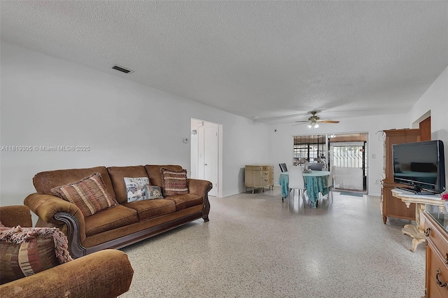 1150 W 69th Pl, Hialeah, FL 33014 - living room featuring a textured ceiling, dark aggregate flooring, and a ceiling fan
