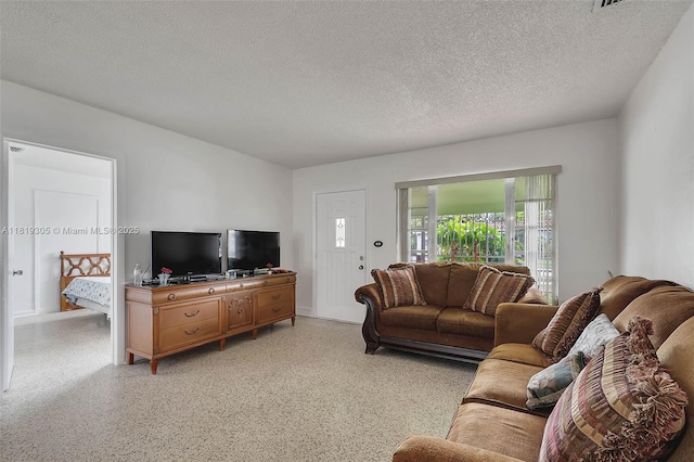 1150 W 69th Pl, Hialeah, FL 33014 - living room featuring a textured ceiling and dark aggregate flooring