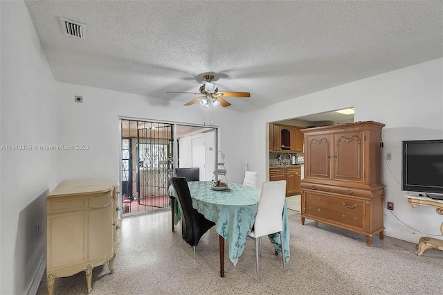1150 W 69th Pl, Hialeah, FL 33014 - dining space featuring ceiling fan, a textured ceiling, and dark speckled floor