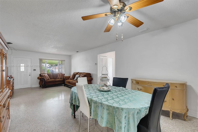 1150 W 69th Pl, Hialeah, FL 33014 - dining area featuring dark aggregate flooring, a textured ceiling, and ceiling fan