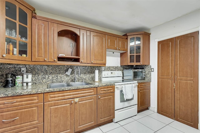 1150 W 69th Pl, Hialeah, FL 33014 - kitchen featuring white electric stove, a sink, light tile patterned floors, backsplash, and brown cabinetry