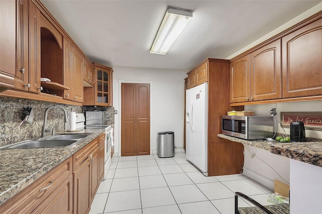 1150 W 69th Pl, Hialeah, FL 33014 - kitchen with white appliances, a sink, light stone counters, and tasteful backsplash