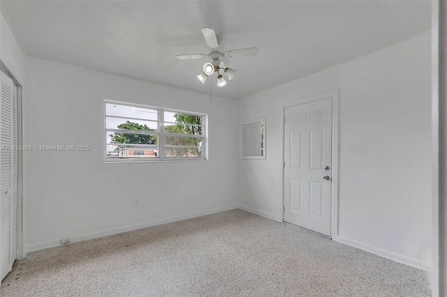1150 W 69th Pl, Hialeah, FL 33014 - unfurnished bedroom with baseboards, speckle patterned floor, ceiling fan, and a closet