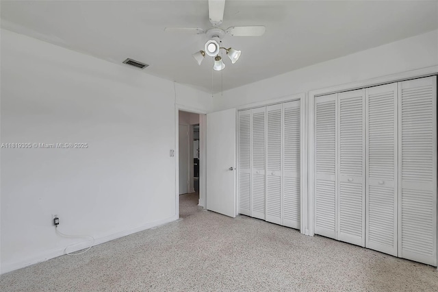 1150 W 69th Pl, Hialeah, FL 33014 - unfurnished bedroom with speckled floor, two closets, and a ceiling fan