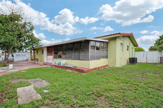 1150 W 69th Pl, Hialeah, FL 33014 - rear view of property featuring a sunroom, cooling unit, stucco siding, and a patio