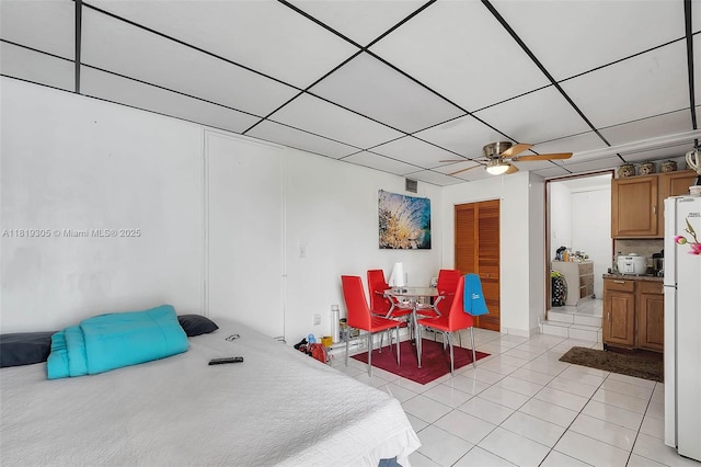 1150 W 69th Pl, Hialeah, FL 33014 - bedroom featuring freestanding refrigerator, light tile patterned flooring, and a ceiling fan