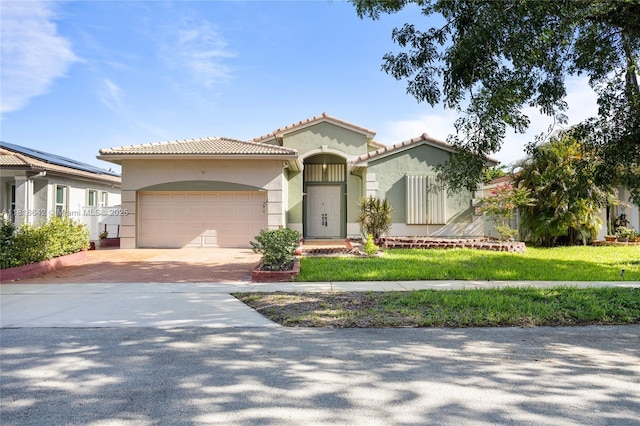 13148 SW 23rd St, Miramar, FL 33027 - mediterranean / spanish-style house with decorative driveway, stucco siding, an attached garage, and a tiled roof