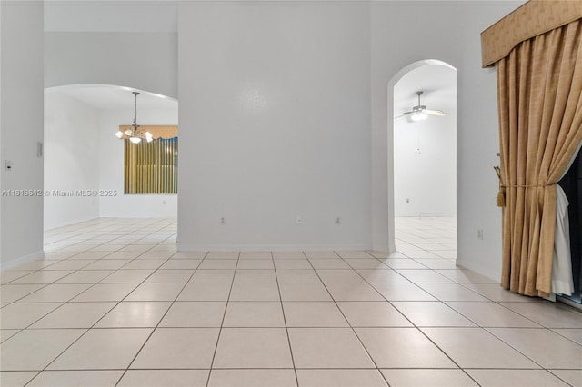 13148 SW 23rd St, Miramar, FL 33027 - unfurnished room with arched walkways, a chandelier, ceiling fan, light tile patterned floors, and a high ceiling