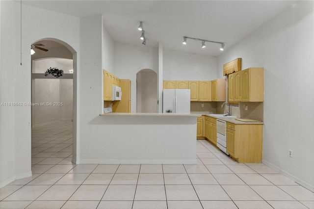 13148 SW 23rd St, Miramar, FL 33027 - kitchen with white appliances, light brown cabinetry, light countertops, light tile patterned floors, and a peninsula