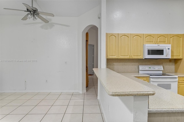 13148 SW 23rd St, Miramar, FL 33027 - kitchen with white appliances, light brown cabinetry, arched walkways, and light countertops