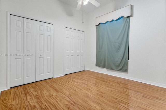 13148 SW 23rd St, Miramar, FL 33027 - unfurnished bedroom with two closets, wood finished floors, and ceiling fan