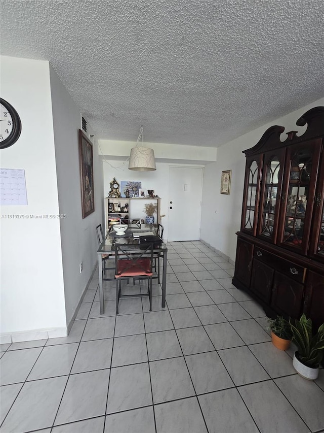 9688 Fontainebleau Blvd Unit 409, Miami, FL 33172 - dining room with a textured ceiling, light tile patterned floors, and an office area