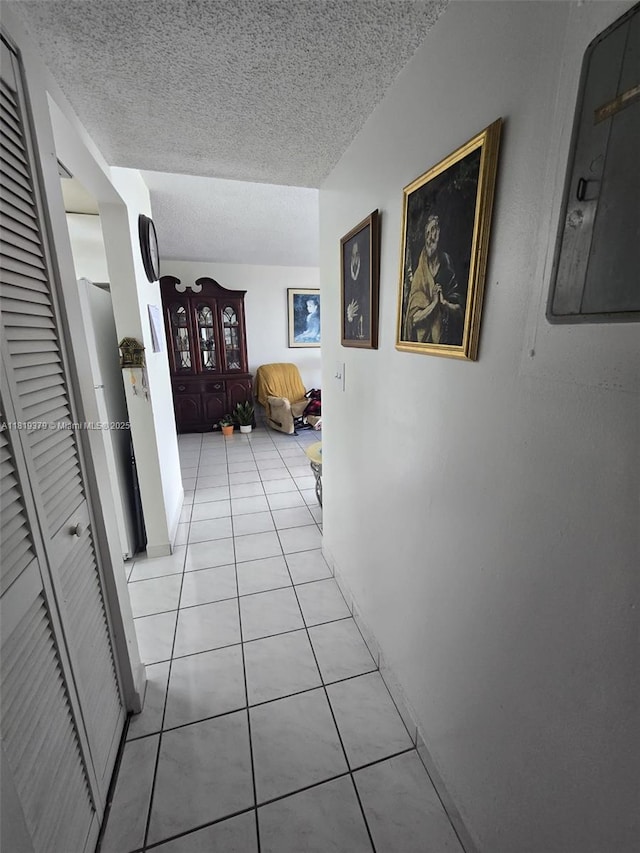 9688 Fontainebleau Blvd Unit 409, Miami, FL 33172 - corridor featuring light tile patterned floors and a textured ceiling