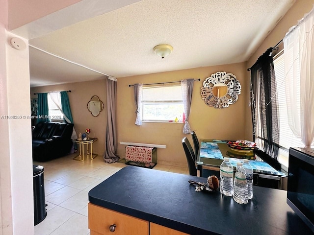 2420 Johnson St Unit 202, Hollywood, FL 33020 - dining space featuring light tile patterned floors and a textured ceiling